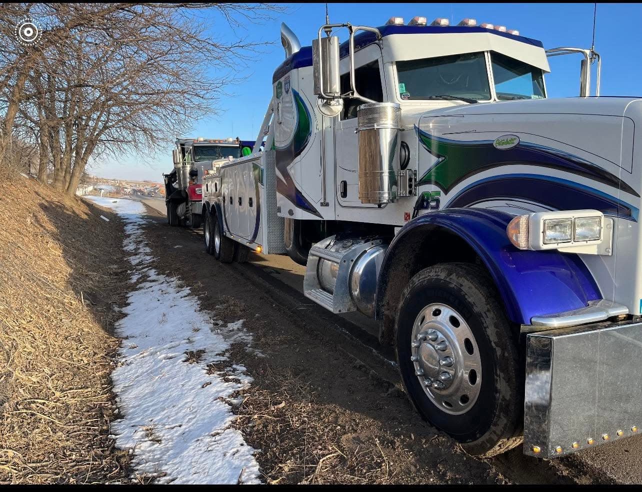 Spartan heavy wrecker on a country road beside a frozen field