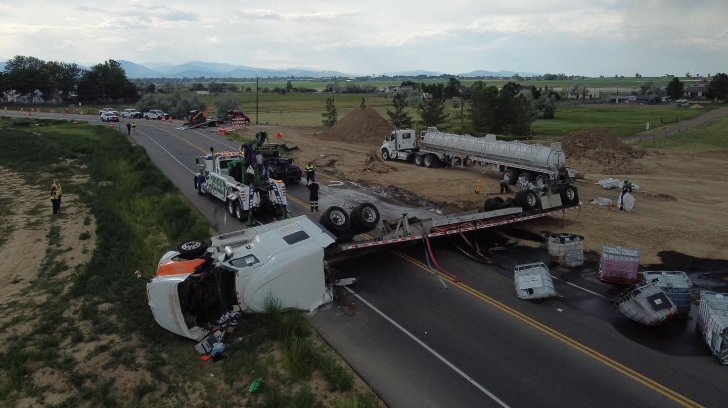 Aerial view of a Spartan recovery operation clearing an overturned tanker from the highway
